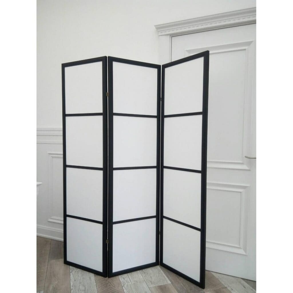 Foldable room divider with black frame and white panels for interior privacy and space separation. Perfect for home, office, or decorative purposes. Durable and stylish design.