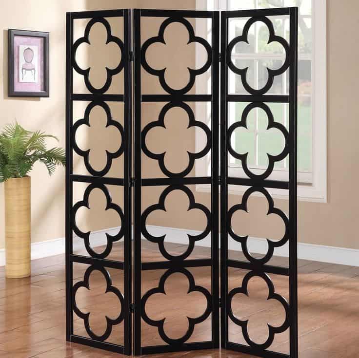 Intricate black lattice room divider screen creates a stylish separation in living spaces, combining aesthetic appeal with functional privacy. Perfect for modern or traditional interior design.